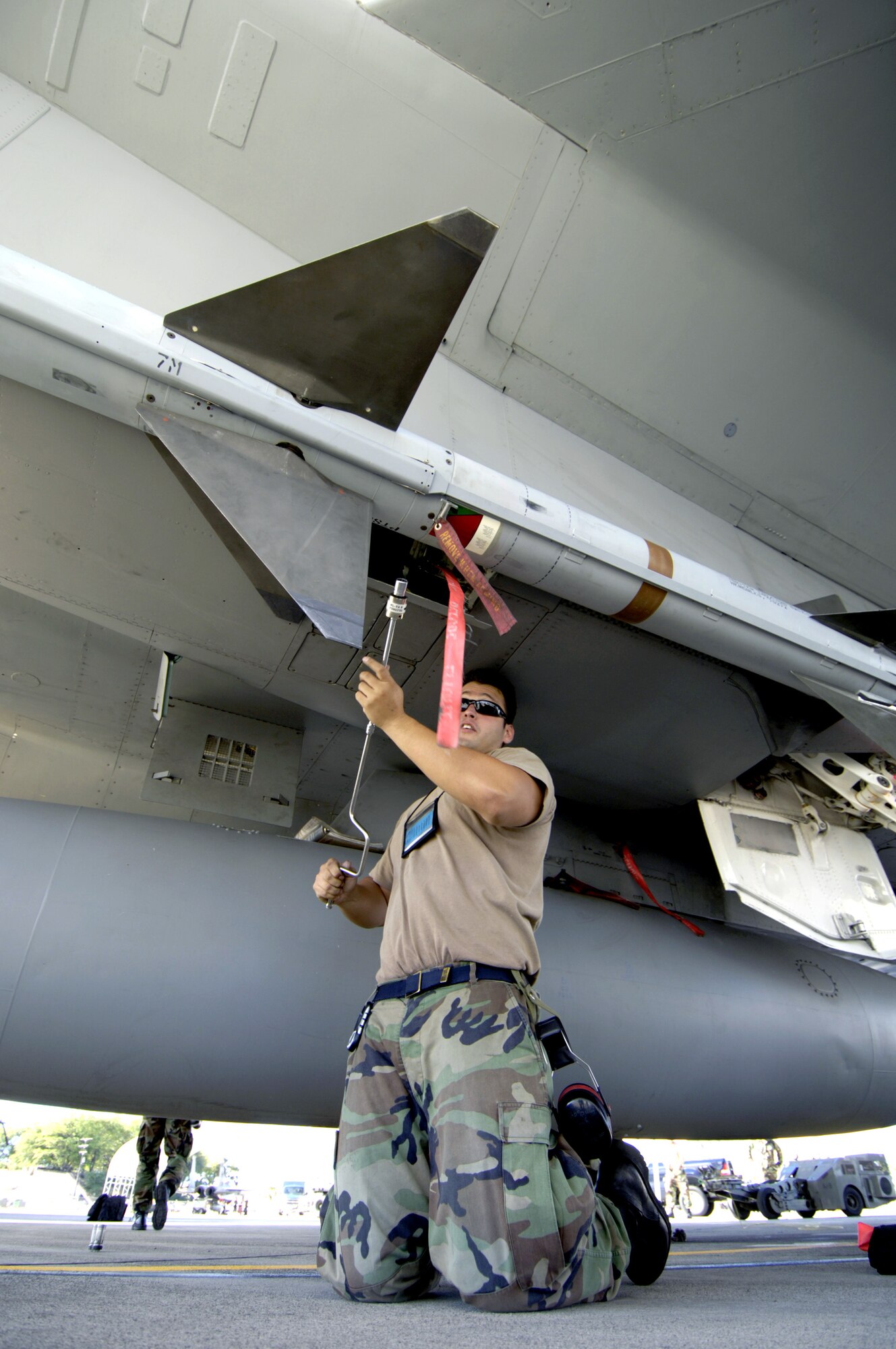 Staff Sgt. Gabriel Coronado loads an AIM-7 Sparrow missile on an F-15 Eagle at Hickam Air Force Base, Hawaii, on July 16 during the Rim of the Pacific Exercise 2006. Sergeant Coronado is with the Hawaii Air National Guard's 154th Aircraft Maintenance Squadron. (U.S. Air Force photo/Tech. Sgt. Shane A. Cuomo)