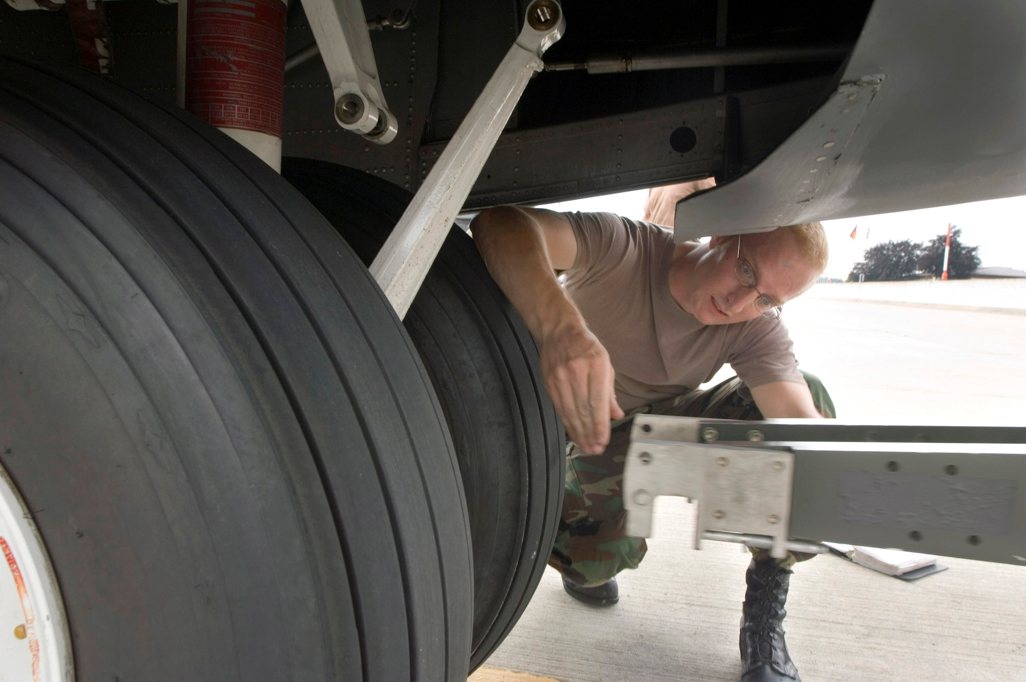 Senior Airman Chris Sanders disconnects the tow hitch from a C-130 Hercules on Thursday, July 13, at Ramstein Air Base, Germany. Airman Sanders is a crew chief on temporary duty for six weeks with the Ohio Air National Guard's 179th Airlift Wing from Mansfield, Ohio. The C-130 unit is flying sorties throughout Europe, Asia and Africa while at Ramstein. (U.S. Air Force photo/Master Sgt. John E. Lasky)