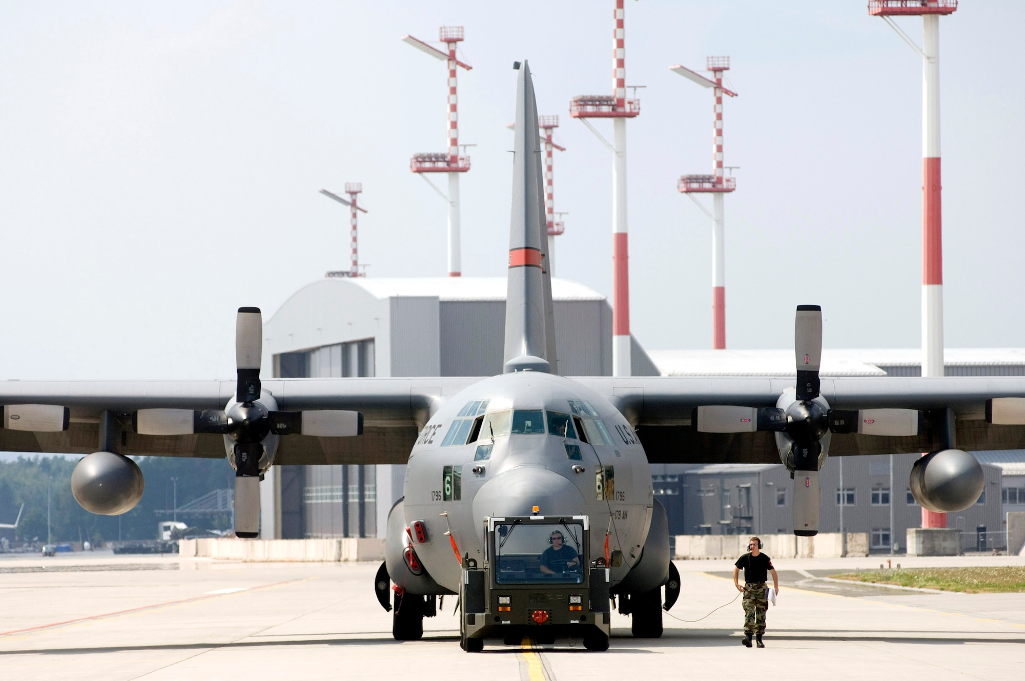 Members of the Ohio Air National Guard tow a C-130 Hercules on Thursday, July 13, at Ramstein Air Base, Germany. Members of the Guard's 179th Airlift Wing from Mansfield, Ohio, are on temporary duty for the next six weeks at Ramstein, where they will fly missions throughout Europe, Asia and Africa. (U.S. Air Force photo/Master Sgt. John E. Lasky)