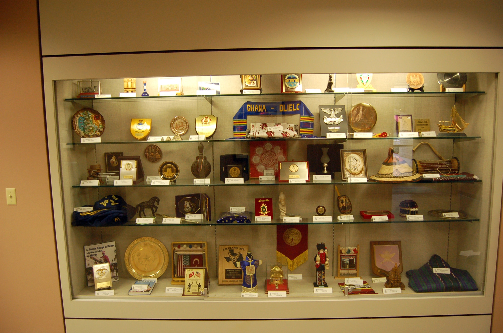 Gifts donated to the Defense Language Institute English language course are displayed in a case at Lackland Air Force Base, Texas. The institute receives so many gifts that they have to rotate new items in every two weeks. (U.S. Air Force photo/Staff Sgt. Jeremy Larlee)
