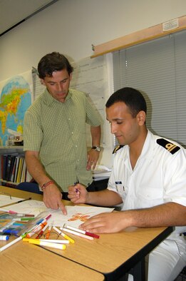 Instructor Antonio Martins discusses a mind mapping exercise with Tunisian Navy Lt. Majed Haj Lajimi at the Defense Language Institute English language course at Lackland Air Force Base, Texas, on July 18. Mind mapping is one of the tactics used to make learning English an easier experience. (U.S. Air Force photo/Staff Sgt. Jeremy Larlee)