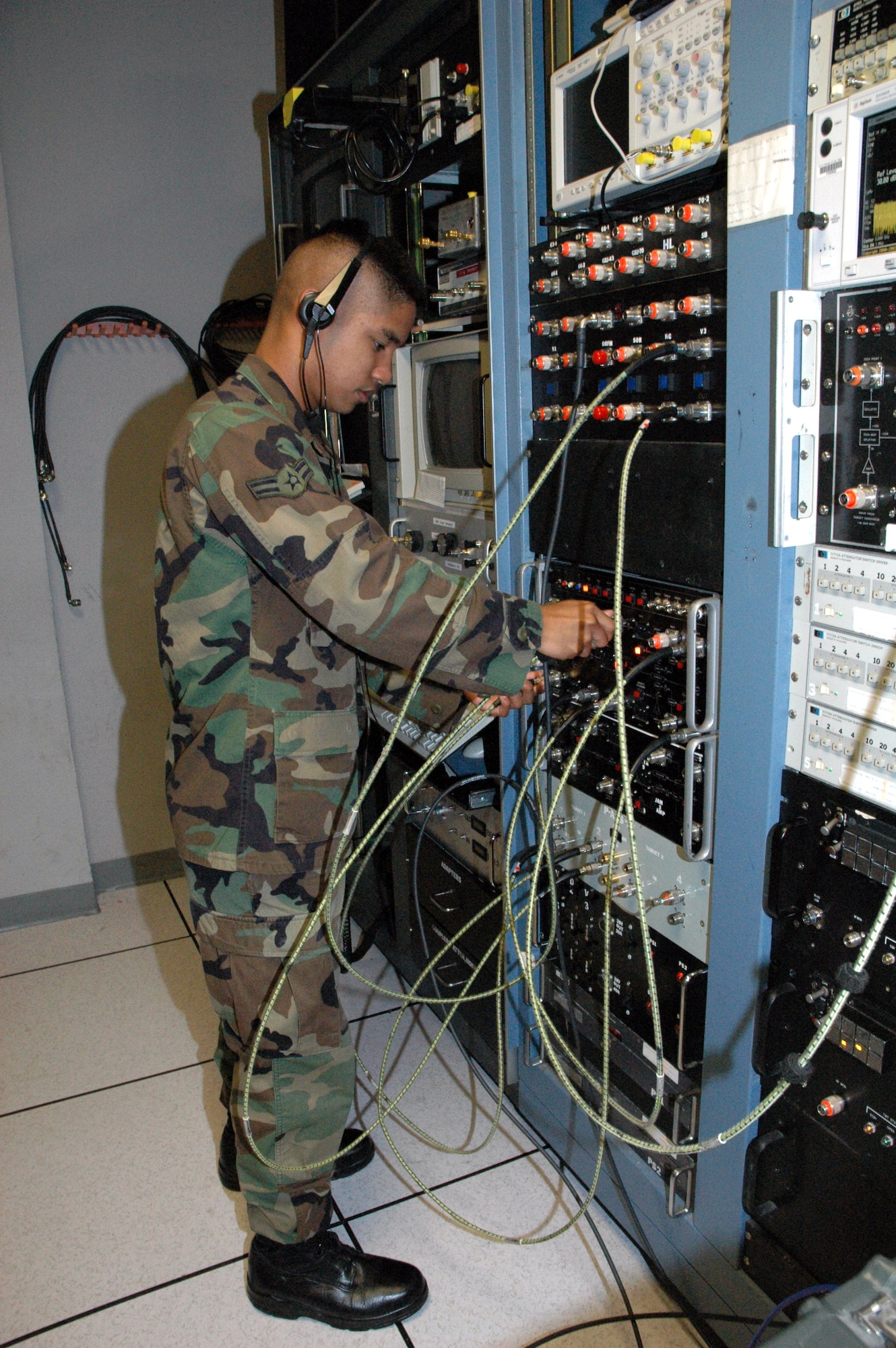 Airman 1st Class Allan Robillos ensures radio frequency-signal connections are correct on the electronic countermeasures attack suite at Tyndall Air Force Base, Fla. Airman Robillos is an electronic warfare technician. (U.S. Air Force photo)
