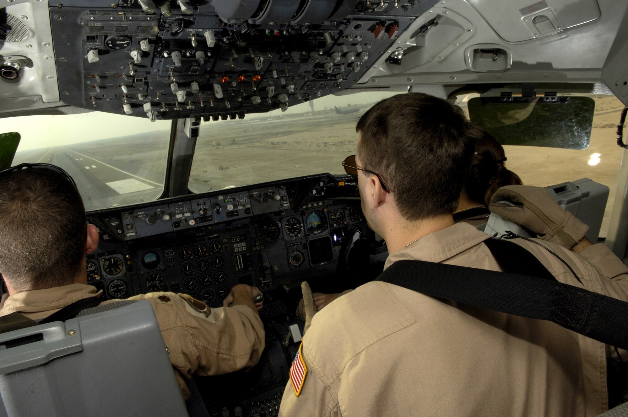 (From left) Maj. James Greathouse, Tech. Sgt. Chris Berry and 1st Lt. Nicole Foster land in a KC-10 Extender on a runway in Southwest Asia after an Operation Iraqi Freedom mission on July 18. The Airmen are with the 908th Expeditionary Air Refueling Squadron. (U.S. Air Force photo/Senior Airman Brian Ferguson)

