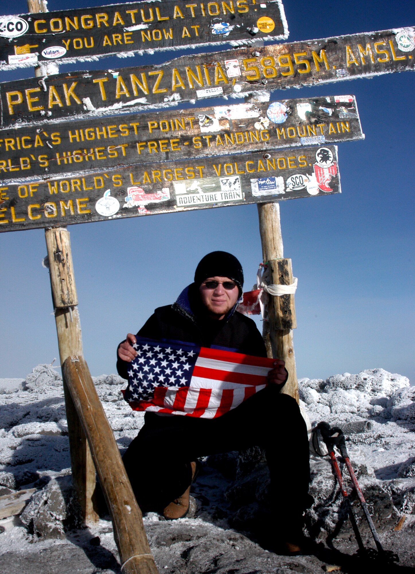 TANZANIA, Africa -- Airman 1st Class Ryan Hockertlotz, a member of Westover Air Reserve Base's 42nd Aerial Port Squadron, crouches on the summit of Mount Kilimanjaro, the world's tallest free-standing mountain. The young porter used only Air Force physical fitness training to prepare for the six-day climb to the top. (Courtesy photo)