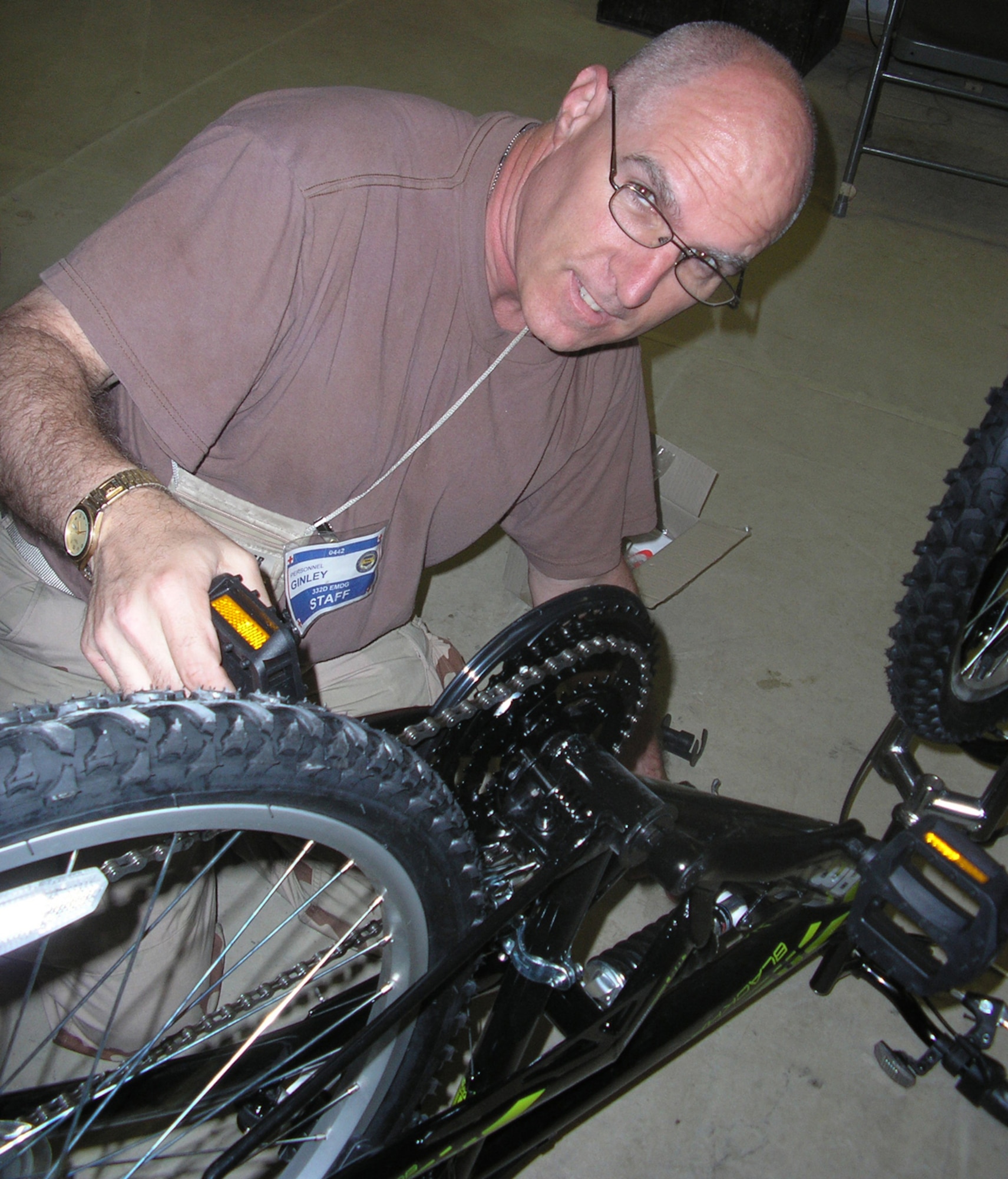 Balad Air Base, Iraq -- Air Force Reserve Major Patrick Ginley, an Air Force Physician's Assistant serving at the Air Force Theater Hospital here has also become known as the "Bicycle Man."  In his off-duty time, Maj. Ginley assembles and repairs bicycles and provides them to his fellow Airmen to use for transportation around the base.  U.S. Air Force photo/Tech. Sgt. Allan Folson