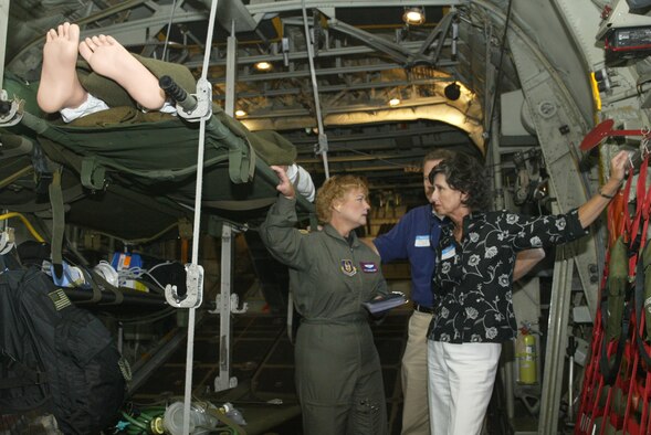 Maj. Mary Youngblood, 94th Aeromedical Evacuation Squadron flight nurse, speaks with two visiting employers while in a demonstration flight during Employer's Day. 