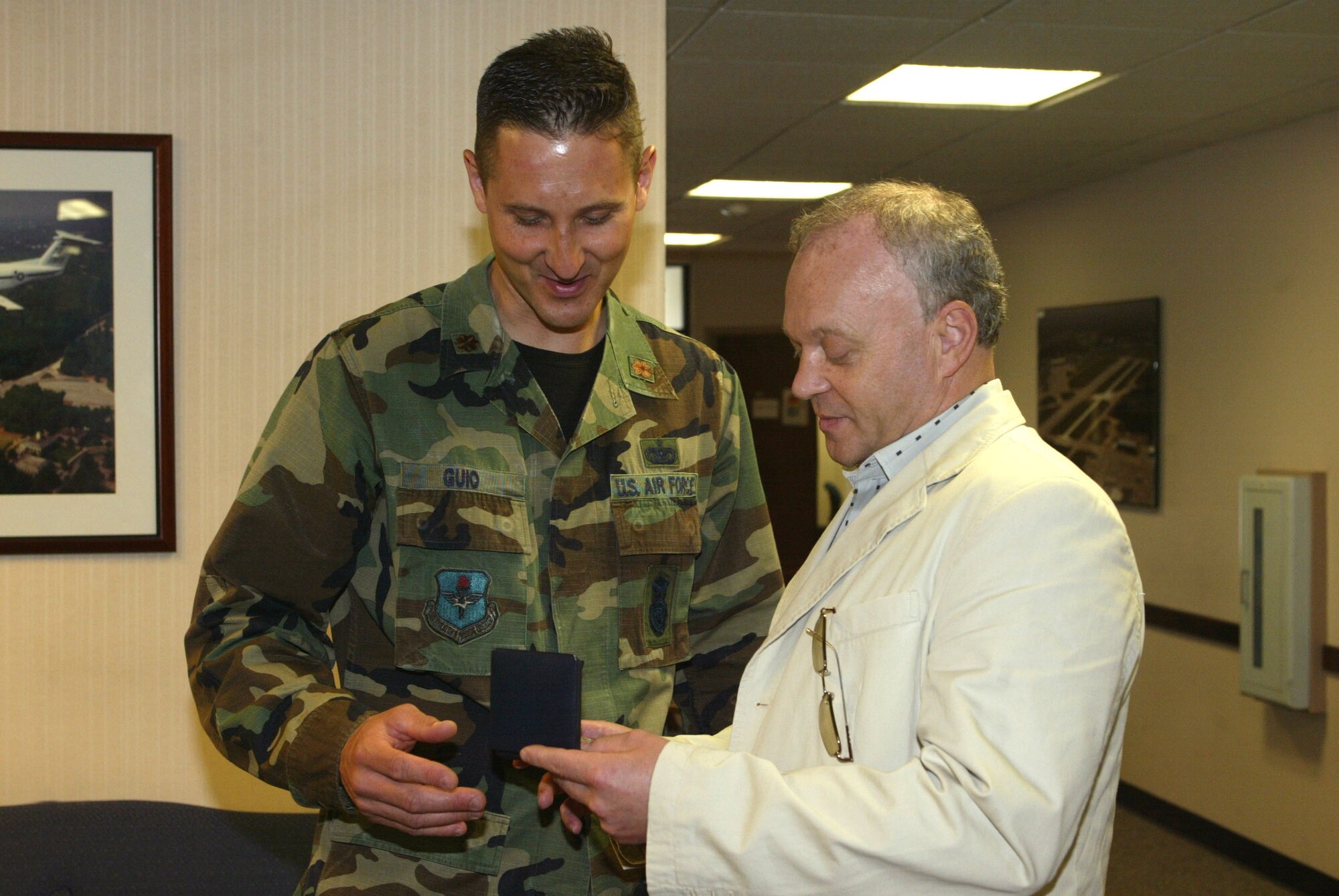 Maj. David Guio, 94th Security Forces Squadron operations officer, accepts a military coin from Lt. Gen. L'ubomir Bulik, Chief of Staff of the General Staff of the Armed Forces of the Slovak Republic.  Major Guio, whose family's heritage is Slovak, met General Bulik when he and a high- level delegation from the Slovak Republic visited Dobbins ARB recently.  Major Guio shared a family photo with the group and talked about the Slovakian meals he enjoyed eating as a child.