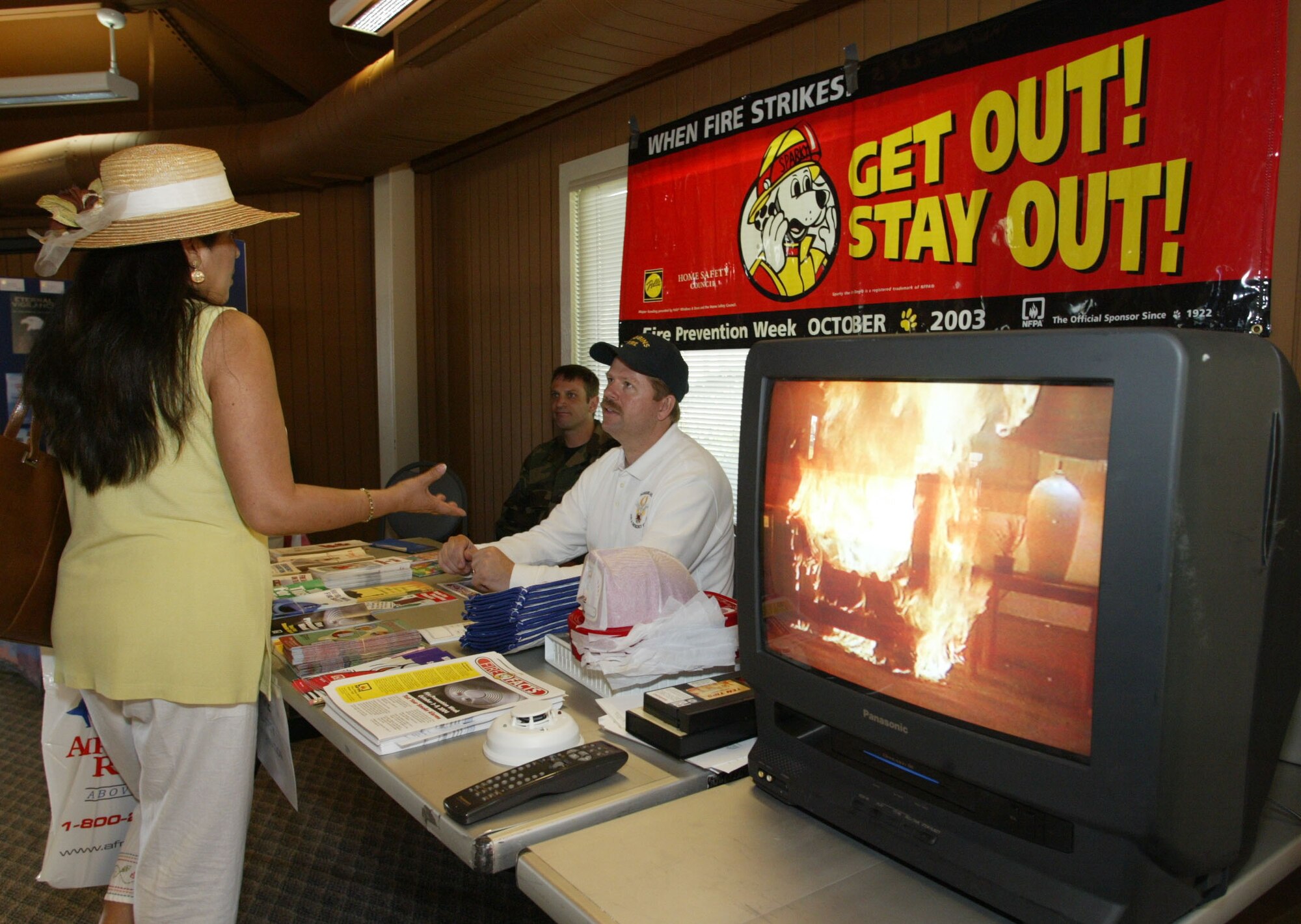 Members of the Dobbins Fire Department Tech. Sgt. Michael Benoit, fire fighter, and Mark Berkenmeier, fire inspector, discuss fire safety with Anita Vaughn.