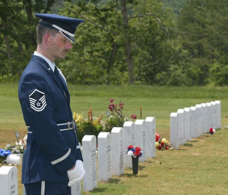 Master Sgt. Bruce See, noncommissioned officer in charge of the Dobbins Air Reserve Base Honor Guard, pauses for a moment of prayer in the opening dedication of a new 775-acre National Cemetery located in Canton, Ga., on June 4. 