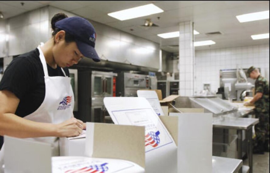 Airman Erica Reyes (foreground), 22nd Services Squadron, first cook, boxes up flight meals while Airman Basic Benjamin Price (right), 22nd Services Squadron, chef, prepares sandwiches for the meals. (U.S. Air Force photo/Master Sgt. Maurice Hessel)