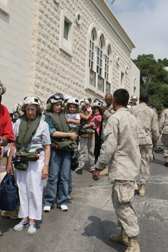U.S. Marines of the 24th Marine Expeditionary Unit help process U.S. citizens before helping them onto Marine Corps CH-53 helicopters heading to Cyprus following their departure from Beirut, Lebanon.::n::U.S. Forces are assisting in the transport of American citizens wishing to leave Lebanon.