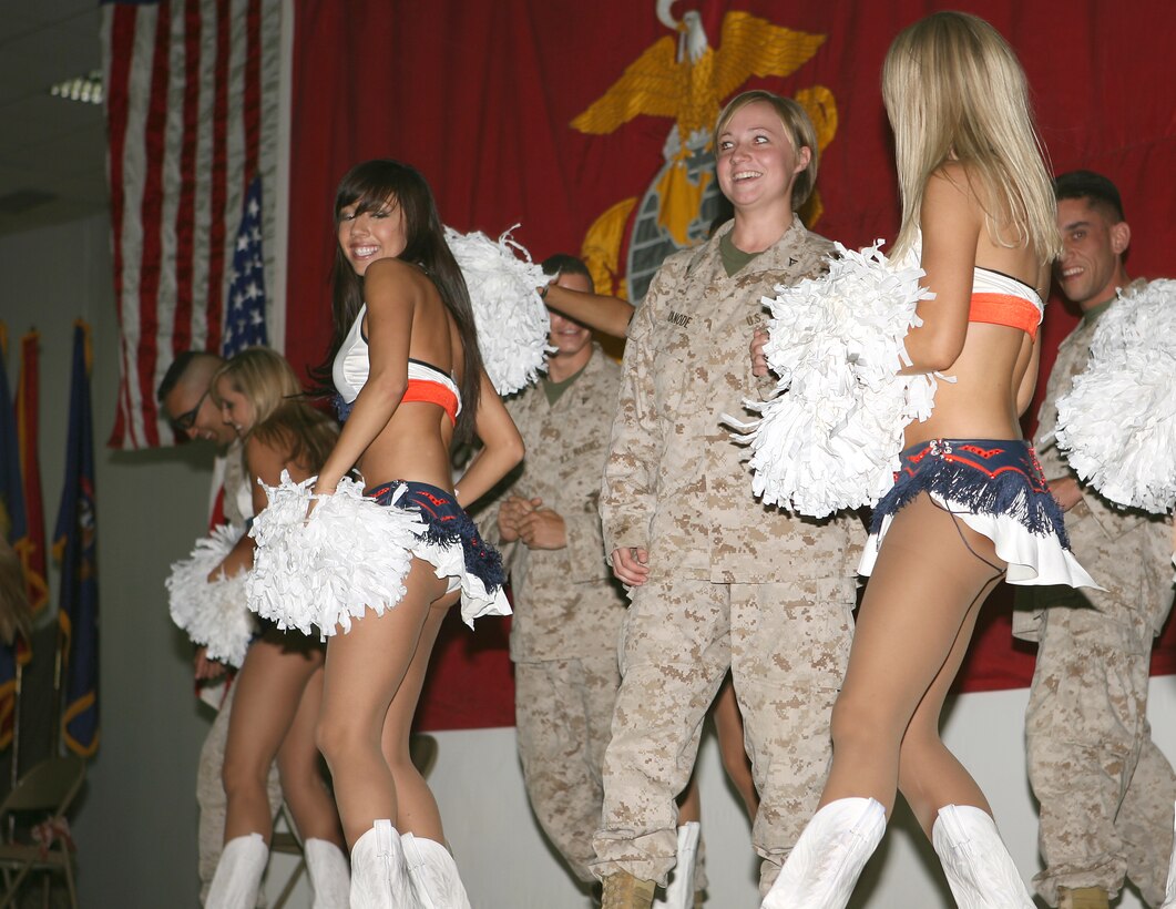 Lance Cpl. Elizabeth A. Canode, a legal administration clerk, Combat Battalion 5, as well as a few other Marines are brought on stage to dance with the Denver Bronco's cheerleaders dance squad.