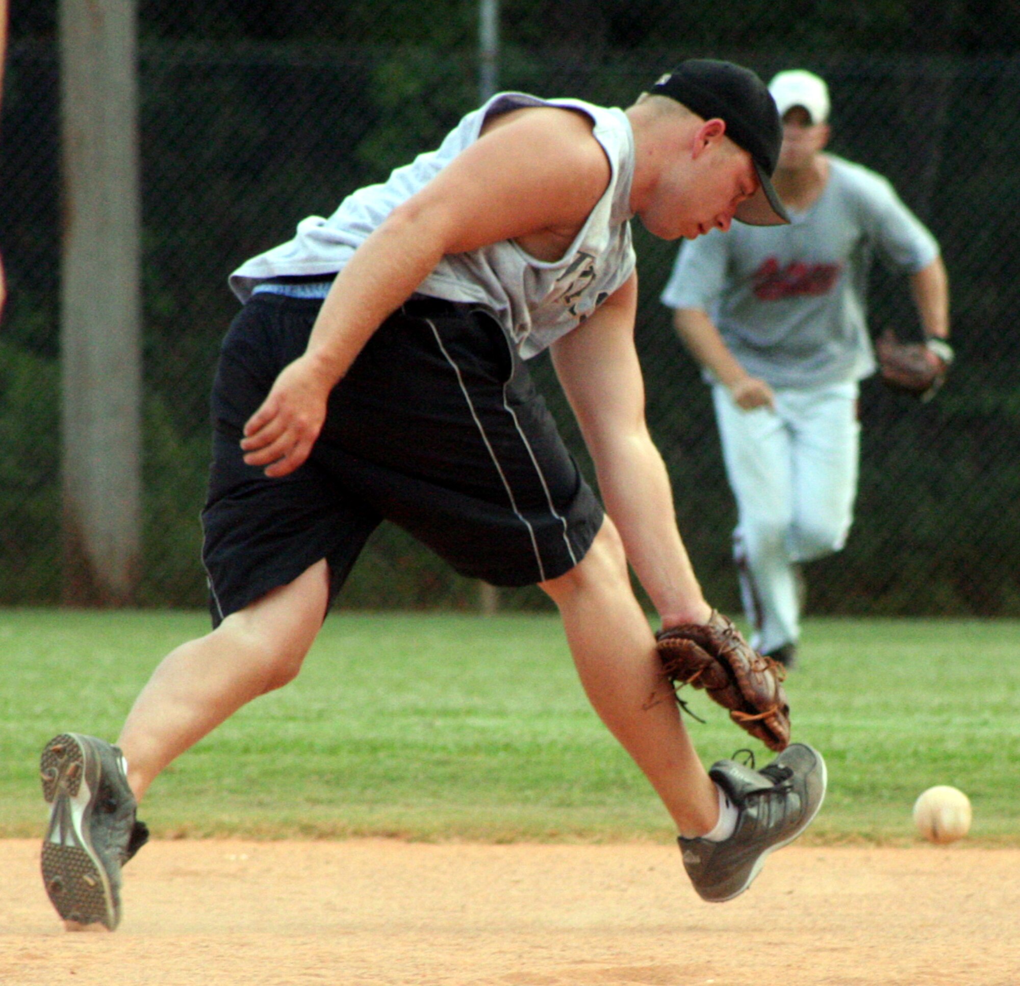 Michael Crager, 16th Equipment Maintenance Squadron 1 shortstop, narrowly misses gloving a Texas leaguer July 18 in a game against the 16th Operations Support Squadron.  EMS 1 beat OSS 8-2. (Air Force photo by Master Sgt. Stuart Camp)