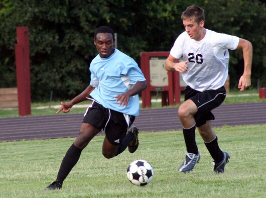 The 16th Component Maintenance Squadron’s Richard Bonsra, left, sprints past the 16th Logistics Readiness Squadron’s Brandon Bertoszek during the second half of the intramural soccer match July 18.  CMS beat LRS 2-1 fueled by two first-half goals.  (Air Force photo by Master Sgt. Stuart Camp)