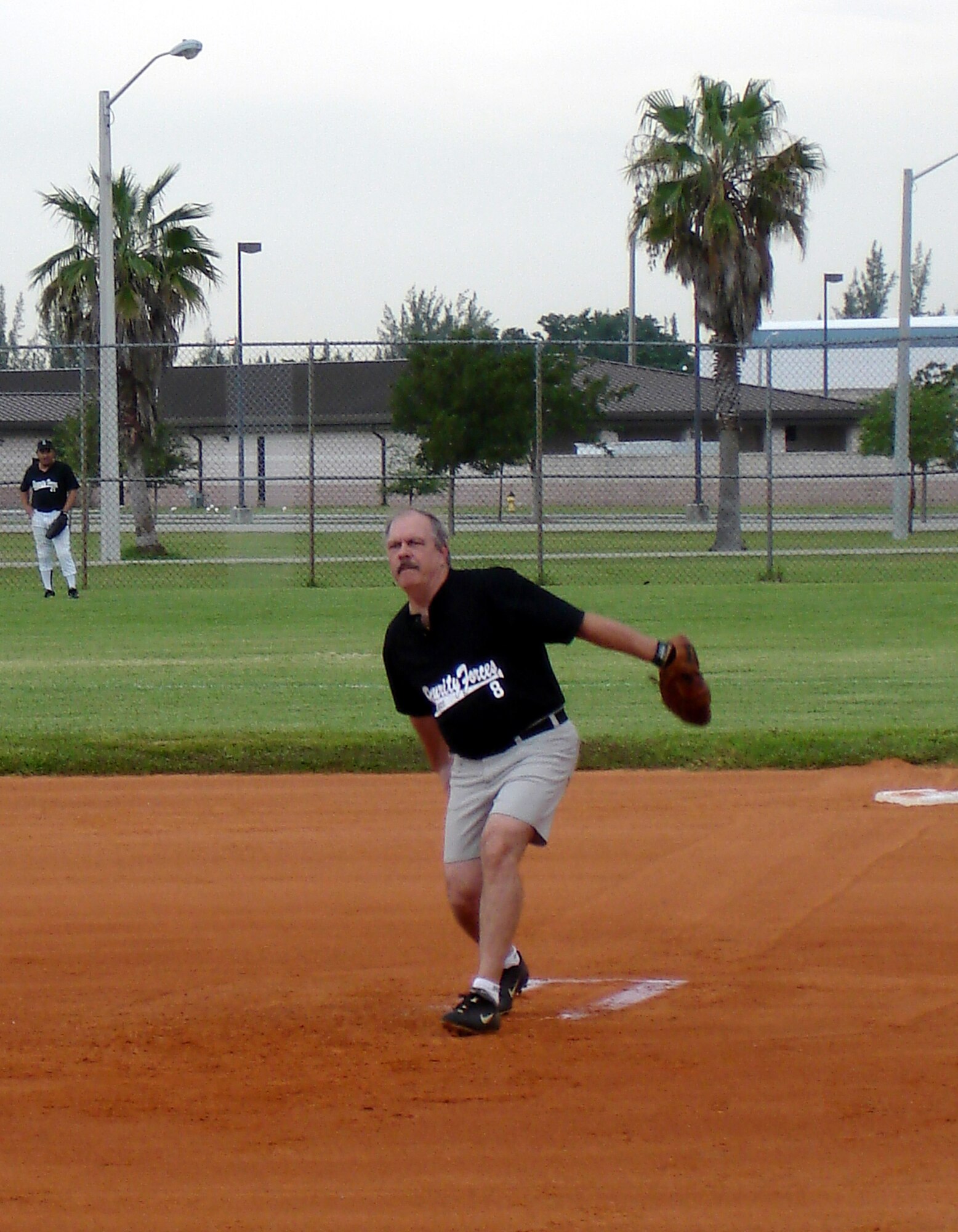Larry "Hoppy" Hopkins pitches during an intramural league softball game at Homestead Air Reserve Base, Fla.  Hoppy plays for the 482nd Security Forces team and works as a Deparment of Defense Police Officer a the base.  He has been playing softball here for 25 years (Air Force photo by Jake Shaw).