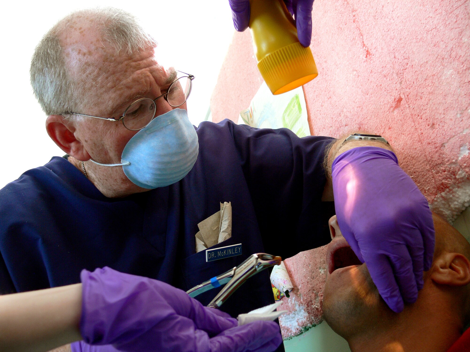 Lt. Col. (Dr.) Mark McKinley relieves a Bosnian patient of both his pain and a badly infected tooth on July 18. Colonel McKinley is with the Maryland Air National Guard's 175th Medical Group on a humanitarian mission in Bosnia and Herzegovina. (U.S. Air Force photo/Master Sgt. Ron Przysucha)

