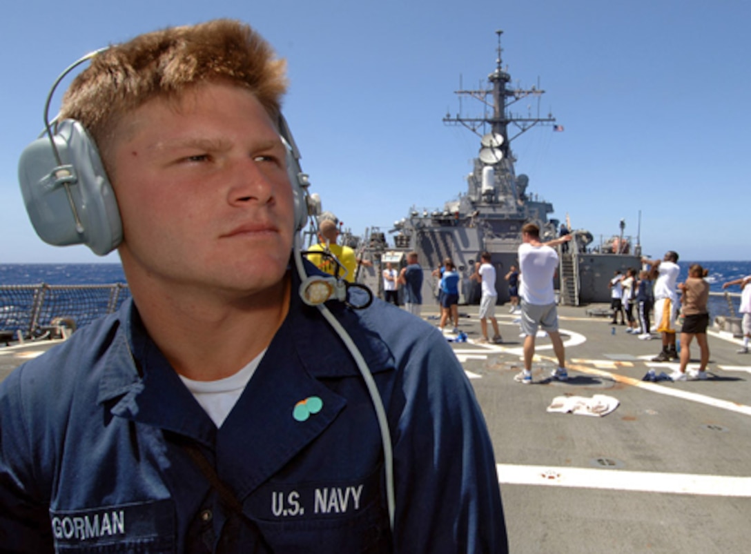 Seaman Apprentice Ryan Gorman vigilantly stands the aft lookout watch as fellow shipmates participate in "Power Hour," a command wide physical training class aboard the Arleigh Burke-class destroyer USS O'Kane during Rim of Pacific 2006 in the Pacific Ocean, July 8, 2006.