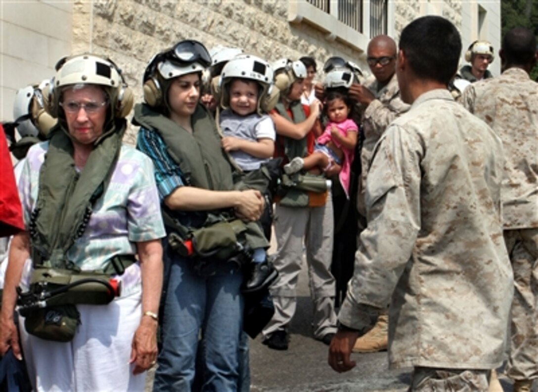 U.S. Marines from the 24th Marine Expeditionary Unit prepare U.S. citizens to be loaded onto Marine Corps CH-53 helicopters heading to Cyprus following their departure from Beirut, Lebanon, July 19, 2006. U.S. Forces are assisting in the transport of American citizens wishing to leave Lebanon. 