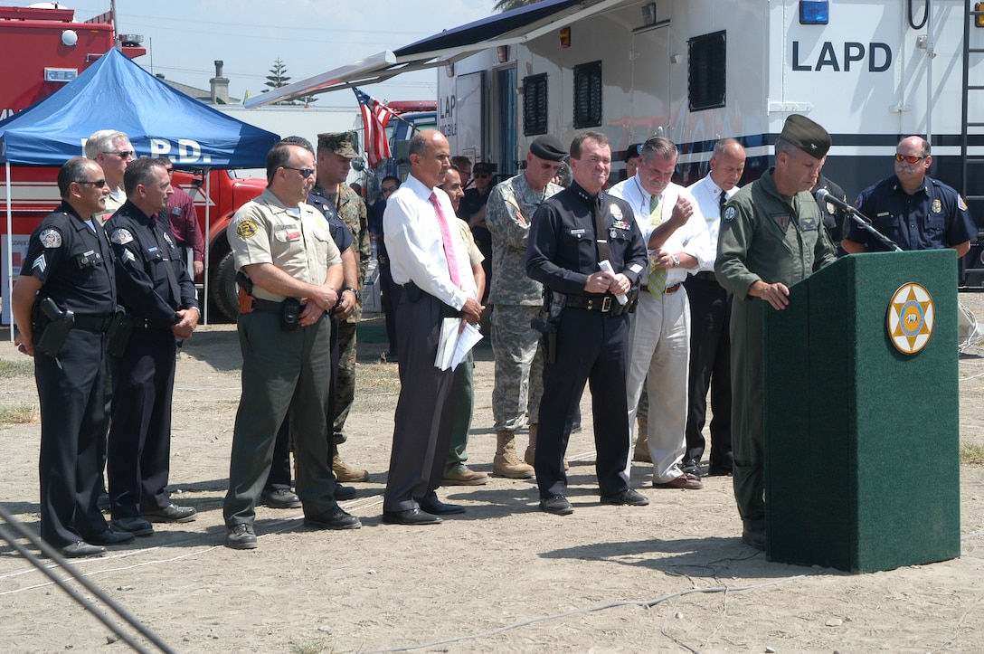 Col. Stephen Ganyard, commanding officer, Marine Aircraft Group 46, addresses the media during a press conference which kicked off a simulated earthquake disaster drill involving first responders from the Los Angeles Police Department, LA County Sheriffs Department, and LA City and County Fire Departments. (Official U S. Marine Corps photo by SSgt P.I. Cox)