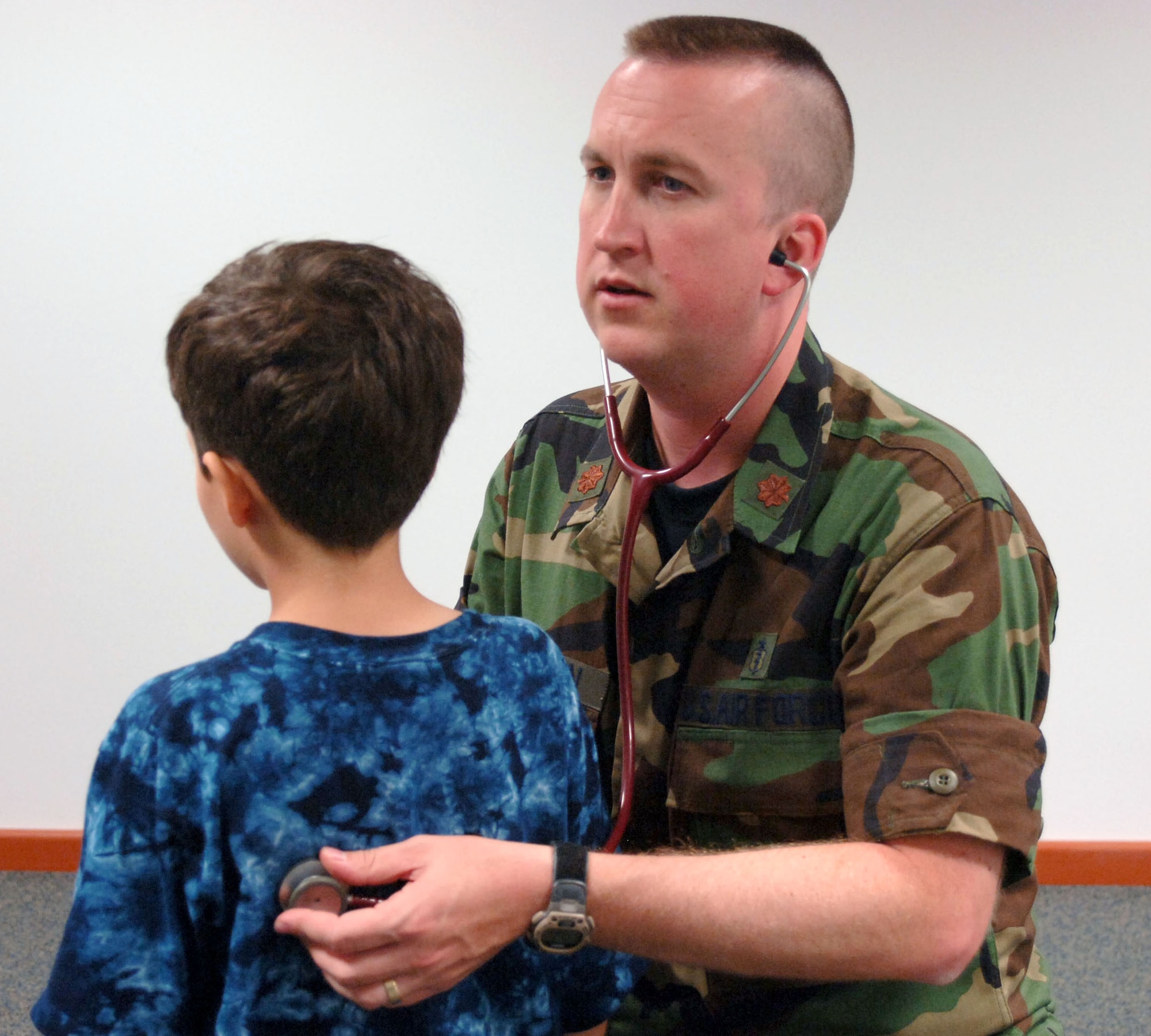 Maj. (Dr.) Matthew Hanson checks 6-year-old Nader Jaafar's breathing during processing at Incirlik Air Base, Turkey, on July 21. Nader is one of 29 American citizens who processed into the base today after departing Lebanon. Major Hanson is a pediatrician with the 39th Medical Group. (U.S Air Force photo/Senior Airman Larry E. Reid Jr.) 
