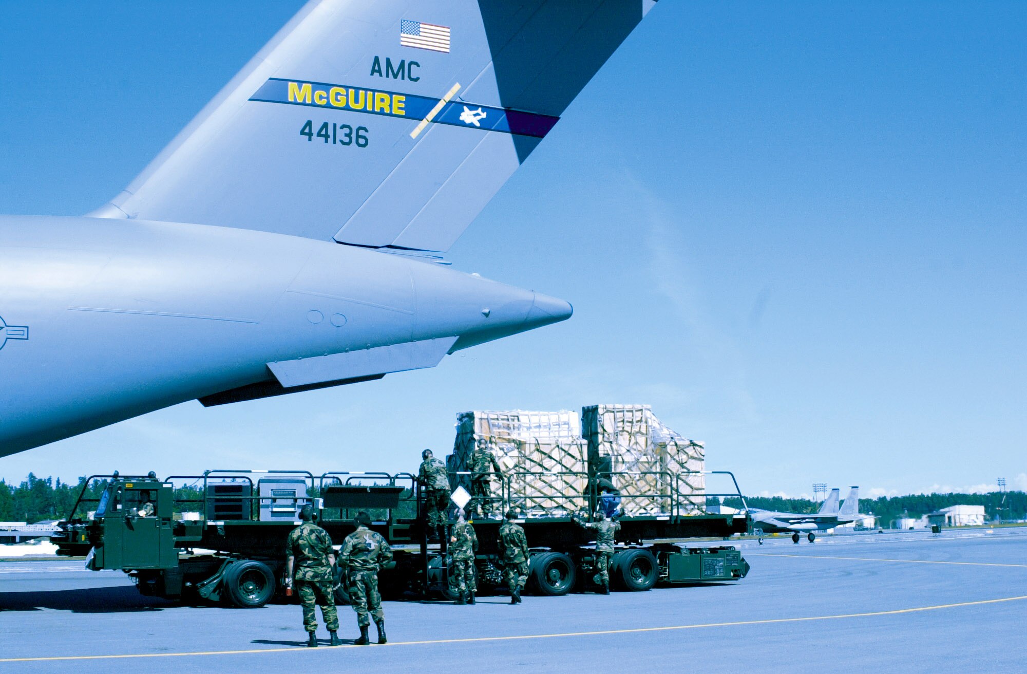 Airmen from Elmendorf Air Force Base, Alaska, and McGuire AFB, N.J., unload a new C-17 Globemaster III simulator at Elmendorf. The C-17 is replacing Elmendorf's aging fleet of C-130 Hercules and will be flown by the 517th Airlift Squadron when they arrive next year. (U.S. Air Force photo/Senior Airman Jared Marquis)
