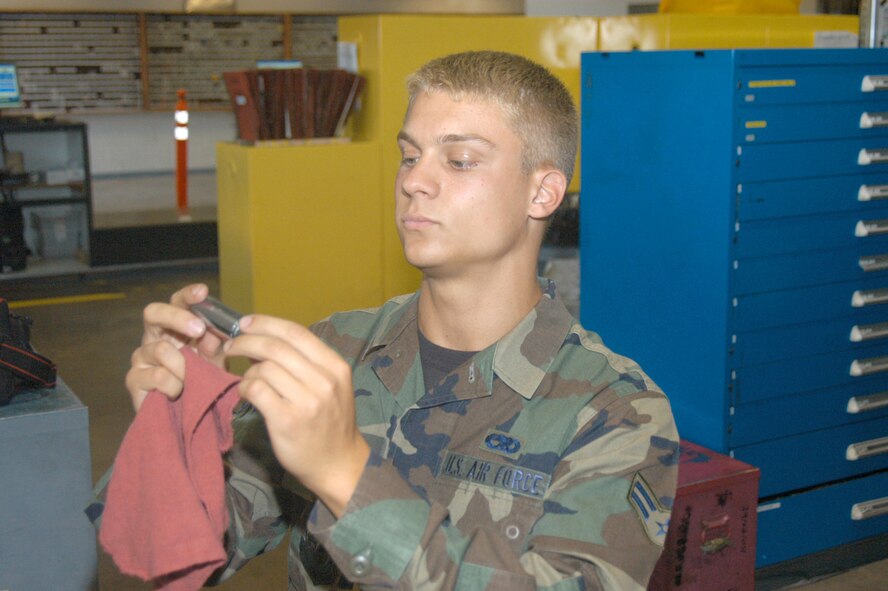 Airman 1st Class Robert Cavaliere, 317th Aircraft Maintenance Squadron, inspects a tool part before putting it back in to the tool box.                                