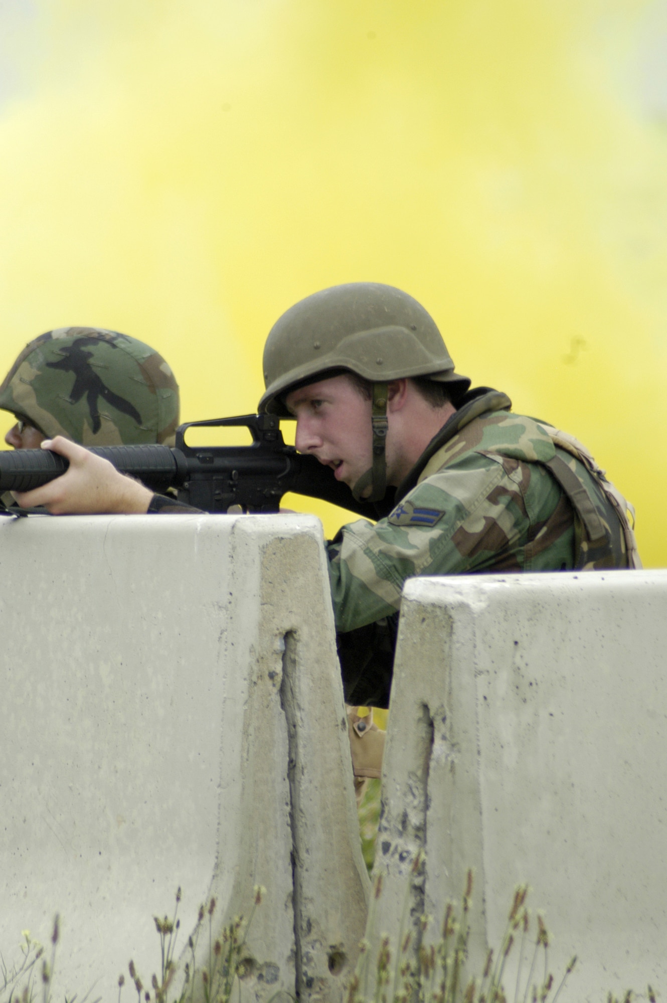 Airman 1st Class James Oberhaus, 436th Services Squadron, fires his weapon at simulated insurgents during Expeditionary Combat Skills Training at Dover Air Force Base July 13. The mandatory training course teaches basic base defense skills to deploying Airmen. (U.S. Air Force photo/Airman 1st Class James Bolinger)