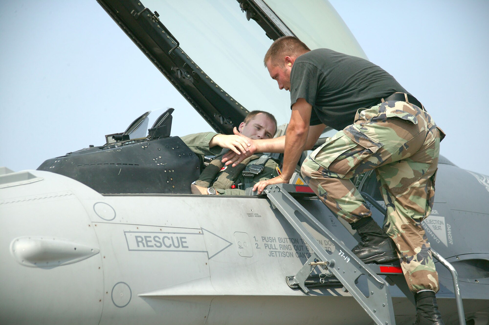 Capt. Ben Russo, 77th Fighter Squadron, pilot shakes hands with Staff Sgt. Jake Kempel, 77th Aircraft Maintenance Unit crew chief, prior to taking off Tuesday in support of Operation Iron Thunder. (U.S. Air Force photo/Senior Airman John Gordinier)