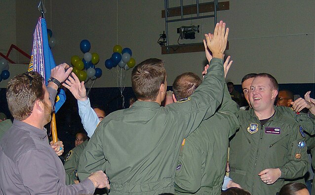 SCHRIEVER AIR FORCE BASE, Colo. -- Members of the 22nd Space Operations Squadron here celebrate their victory at the 50th Space Wing's Guardian Challenge score posting Jan. 13. This is the first time a squadron outside the 50th Operations Group has won the wing-level shootout. The 22nd SOPS team will travel to Peterson Air Force Base, Colo., in August to represent Schriever at the Air Force Space Command competition. (U.S. Air Force photo/Alex Groves)
