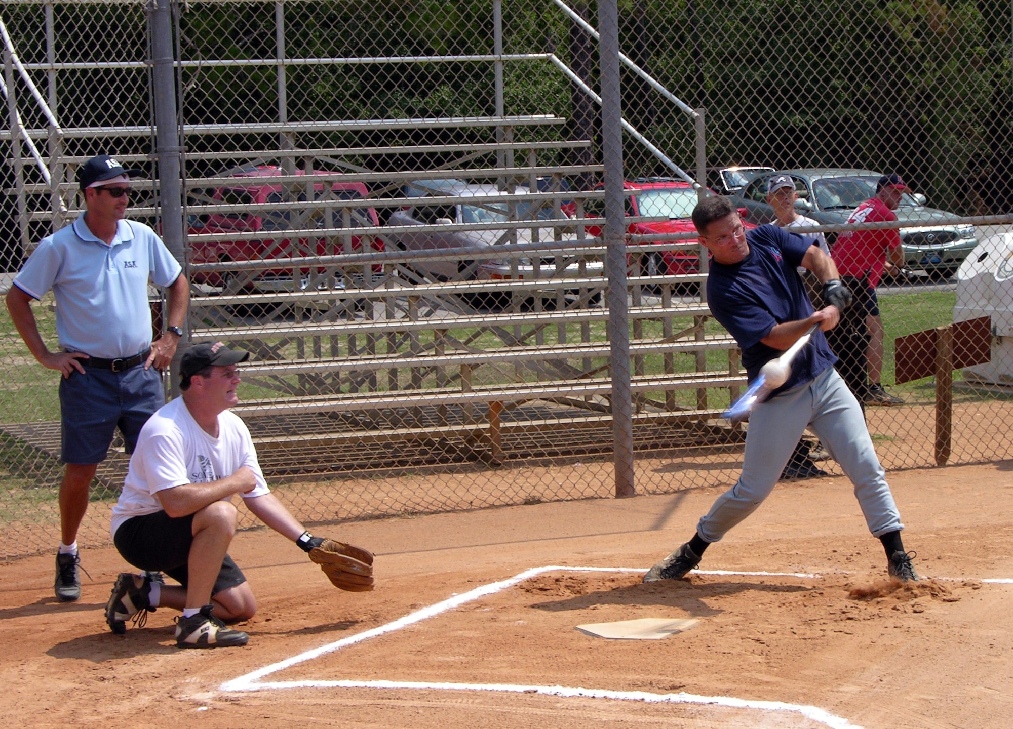 A player from the Air Force Special Operations Command over-30 intramural softball team slugs a pitch in the first inning of the championship game Wednesday against the 505th Command and Control Wing team.  Although AFSOC drew first blood with a single run, the 505th CCW tallied four runs in the third inning. Unwilling to surrender and trailing 5-2 after five innings, AFSOC rallied in the sixth inning, scoring twice.  Then they produced three runs in the seventh.  The 7-5 victory forced a winner-take-all final game played Thursday, which the 505th CCW went on to win 8-4.