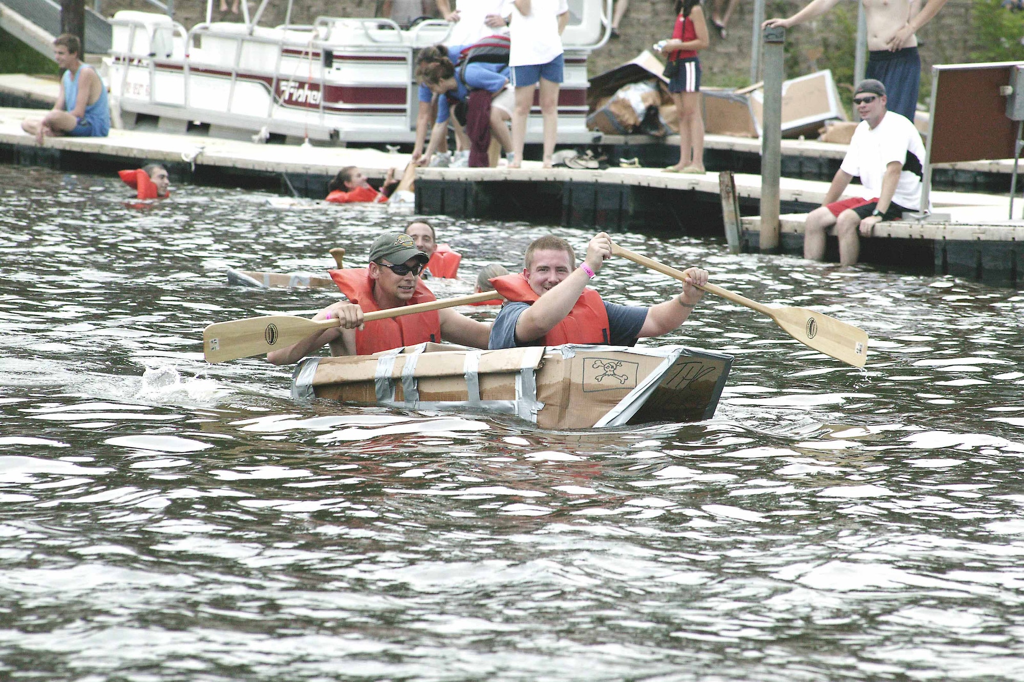 Staff Sgts. Aaron Wollenberg and John Zigler, 20th Equipment Maintenance Squadron, paddle their boat "Angry Pirates" to victory July 14 during Junior Enlisted Appreciation Day at Lake Wateree.  In addition to the two sergeants, the team was comprised of Senior Airman Curt Howard, 20th EMS, and Justin Zigler, borther of Sgt. Zigler.   (U.S. Air Force photo/Tarsha Storey)