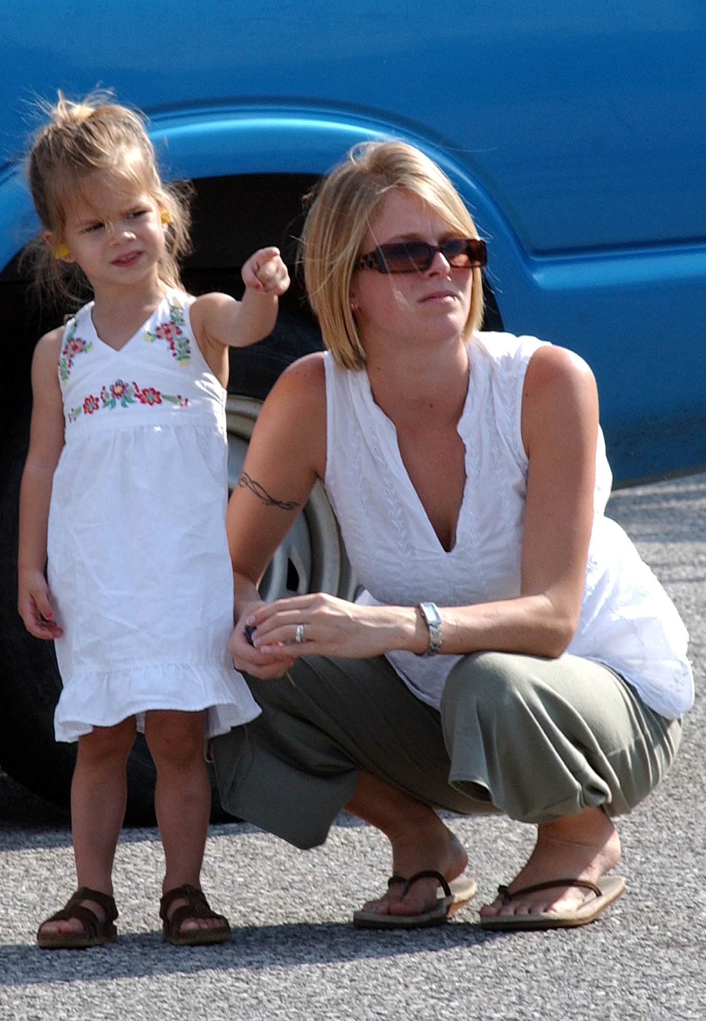 Jordin Pressler (left) and her mother, Laci, wait on the tarmac at Duke Field July 14 as the MC-130E Combat Talon I and Senior Airman Steve Pressler, 8th Special Operations Squadron, return from a deployed location. (Air Force Photograph by Senior Airman Jessica Klingler)