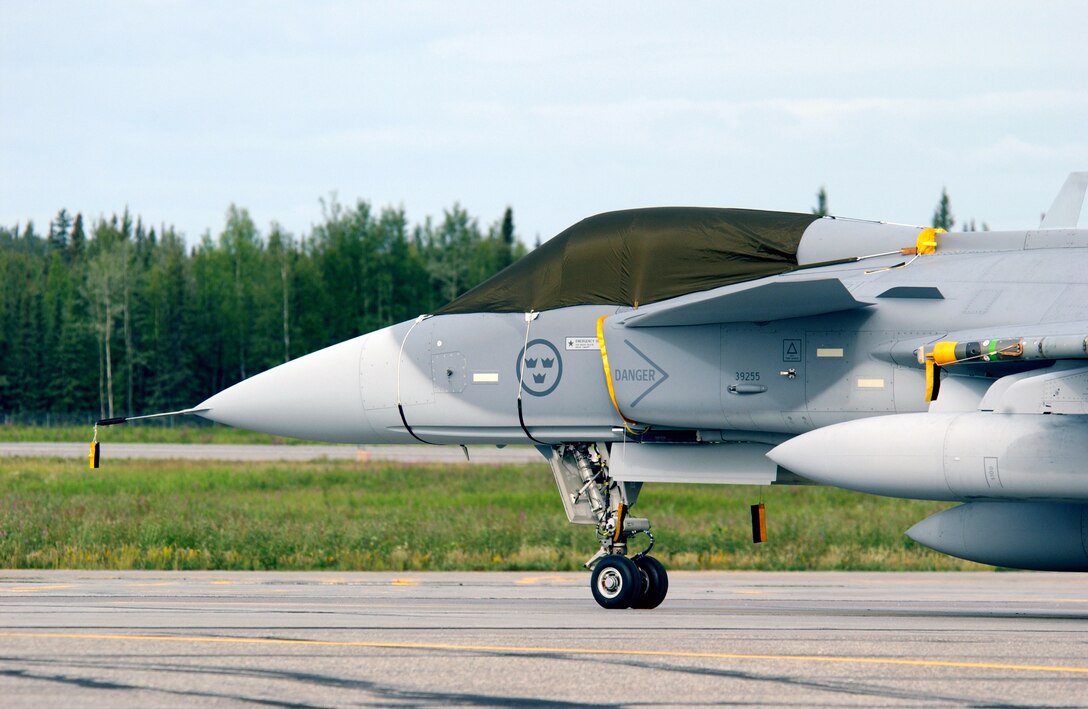 A JAS 39 Gripen from the Swedish Air Force's Tango Red unit based at Malmen Air Base, Sweden, sits on the flightline at Eielson Air Force, Alaska, on July 18 in preparation for Cooperative Cope Thunder 2006. The combined joint air training exercise provides scenarios that are as realistic as combat within the constraints of the training environment. (U.S. Air Force photo/Staff Sgt. Joshua Strang)