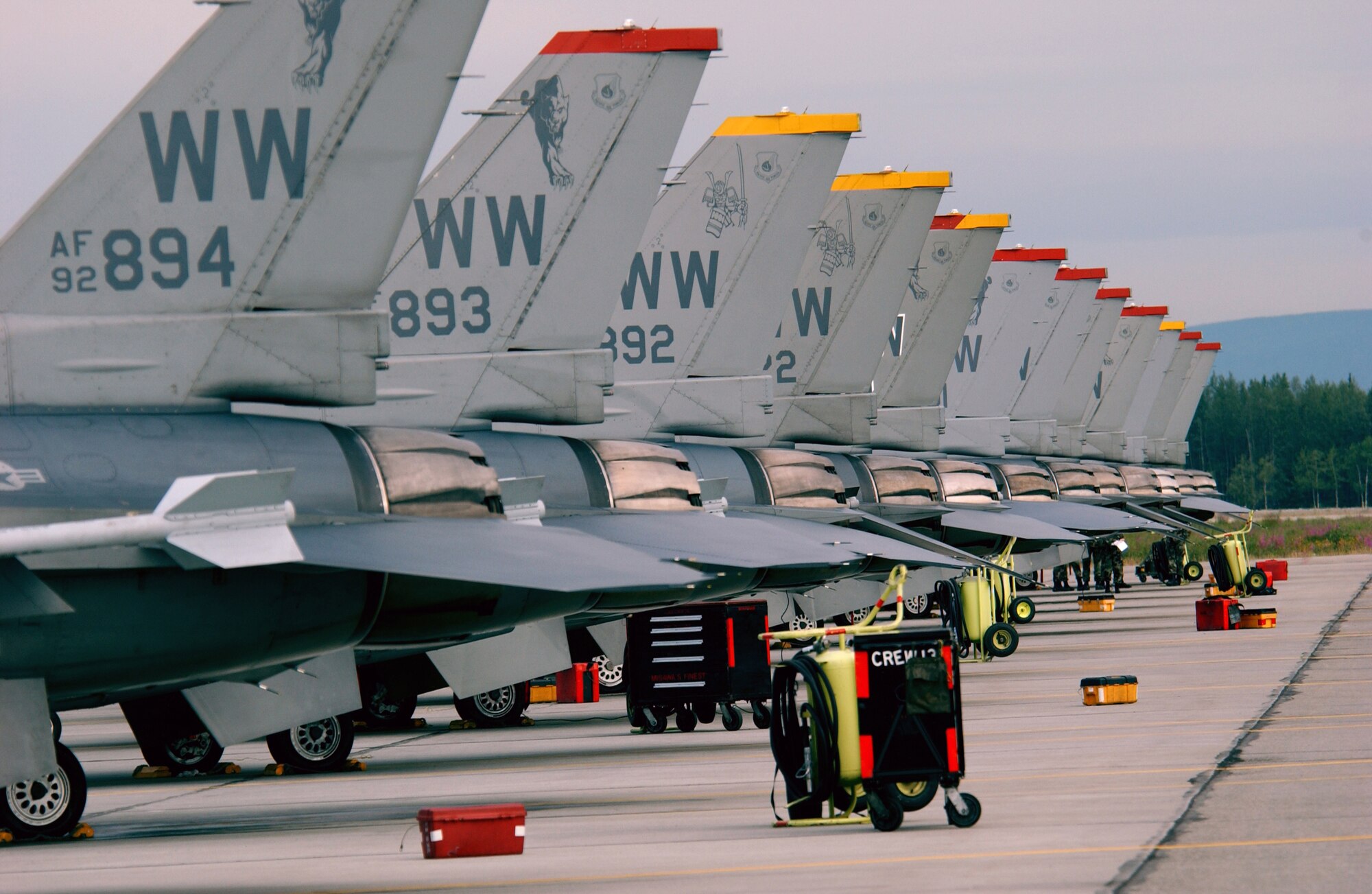 F-16 Fighting Falcons from the 13th Fighter Squadron at Misawa Air Base, Japan, sit on the flightline at Eielson Air Force, Alaska, on July 18 in preparation for Cooperative Cope Thunder 2006. The combined joint air training exercise provides scenarios that are as realistic as combat within the constraints of the training environment. (U.S. Air Force photo/Staff Sgt. Joshua Strang)