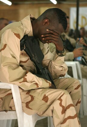 Petty Officer 2nd Class Timothy Anderson, mourns one of his own, a fallen sailor, during  a  memorial service July 21, 2006 for Petty Officer 1st Class Jerry A. Tharp, held at the Camp Taqaddum base chapel. Tharp, a Seabee with Naval Mobile Construction Battalion 25 and a native of Aledo, Ill., was killed in action while operating in the restive Al Anbar Province of Iraq July 12, 2006.