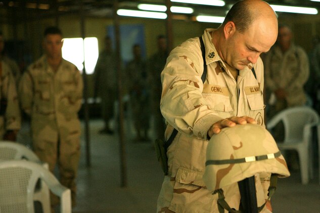 Chief Petty Officer Ronald L. Genco pauses for a moment to remember one of his own, a fallen sailor, during a memorial service July 21, 2006 for Petty Officer 1st Class Jerry A. Tharp, held at the Camp Taqaddum base chapel. Tharp, a Seabee with Naval Mobile Construction Battalion 25 and a native of Aledo, Ill., was killed in action while operating in the restive Al Anbar Province of Iraq July 12, 2006.