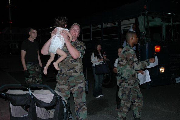 RAMSTEIN AB, Germany -- Airman 1st Class Brendan Fassl, 723rd Air Mobility Squadron Passenger Services, picks up an infant to carry onto a bus to transport American citizens displaced from Lebanon to a C-17 waiting to return them to the United States July 23.
(Photo by SMSgt Stefan Alford)
