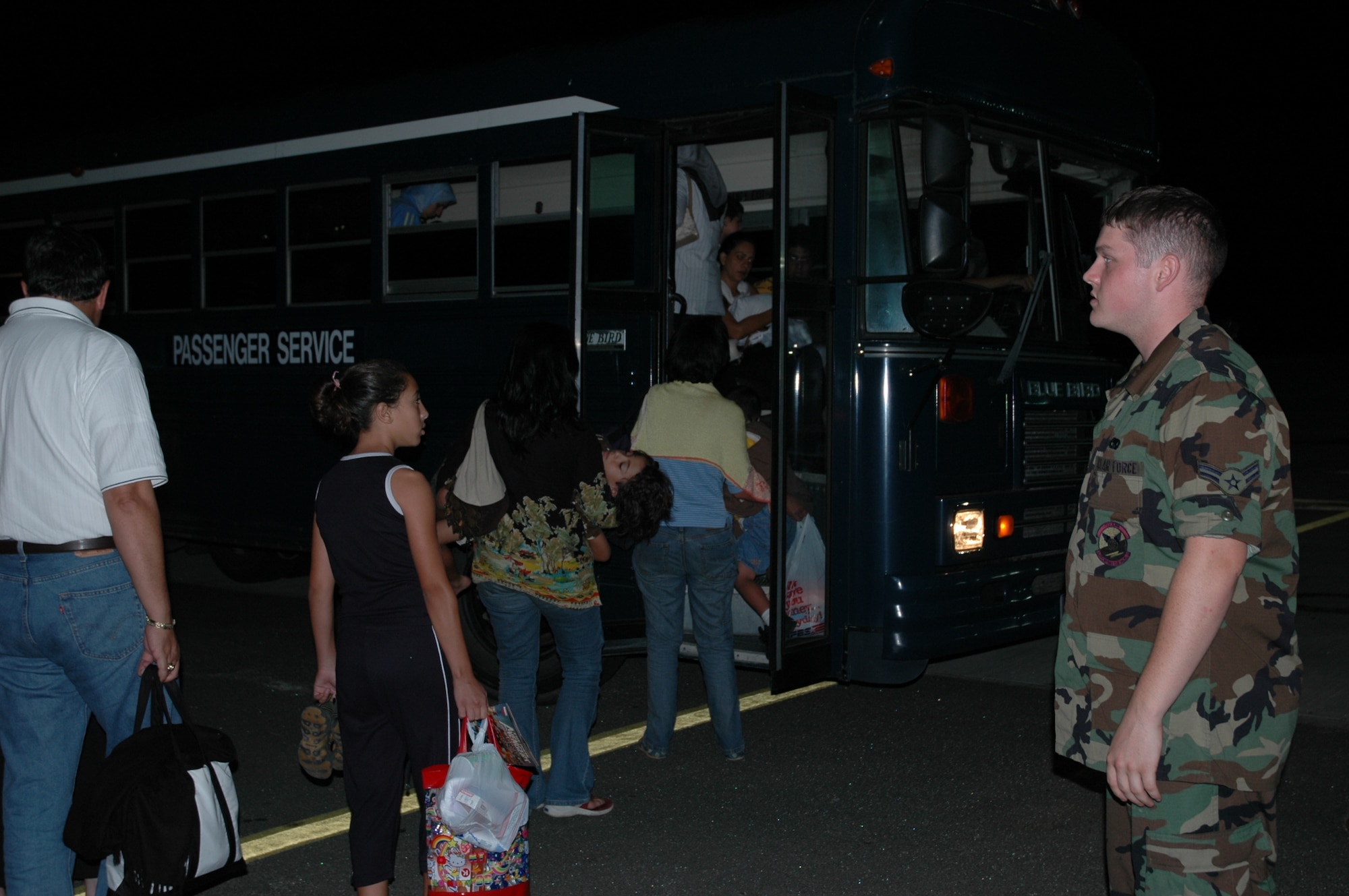 RAMSTEIN AB, Germany -- Airman 1st Class Cody Orick, 723rd Air Mobility Squadron Passenger Services, directs American citizens displaced from Lebanon onto a bus to transport them to a C-17 waiting to return them to the United States July 23.
(Photo by SMSgt Stefan Alford)