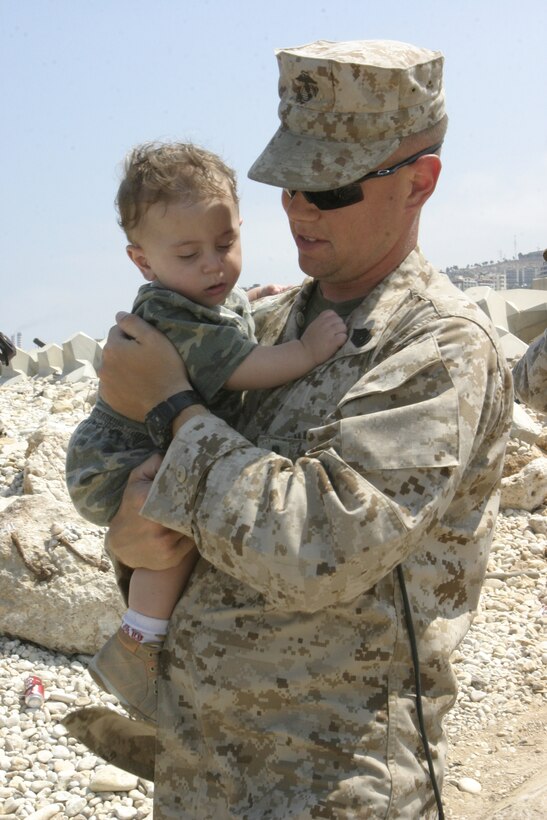 A U.S. Marine from the 24th Marine Expeditionary Unit carries an American child departing Beirut, Lebanon, July 22, 2006. At the request of the U.S. Ambassador to Lebanon and at the direction of the Secretary of Defense, the United States Central Command and elements of Task Force 59 are assisting with the departure of U.S. citizens from Lebanon.  (U.S. Marine Corps photo by Lance Cpl. Andrew J. Carlson) (Released)