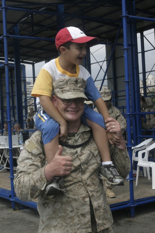 Cpl. Justin Muir, a combat engineer with Marine Expeditionary Unit Service Support Group 24 and a native of Canastota, N.Y., plays with an American child before the child departs Beirut, Lebanon, July 22. At the request of the U.S. Ambassador to Lebanon and at the direction of the Secretary of Defense, the United States Central Command and elements of Task Force 59 are assisting with the departure of U.S. citizens from Lebanon.  (U.S. Marine Corps photo by Lance Cpl. Andrew J. Carlson) (Released)::n::::n::