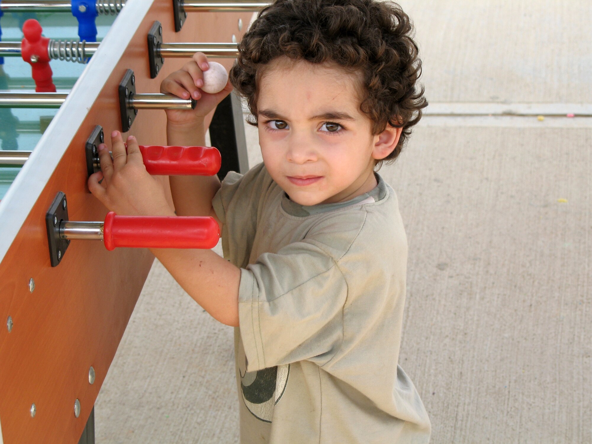 A young American who departed Lebanon plays with a foosball table at Incirlik Air Base, Turkey, on July 22. The base has provided telephones, Internet service, television, beds and showers to the displaced American citizens while they wait to travel to the United States. (U.S. Air Force photo/Master Sgt. Bob Herron)
