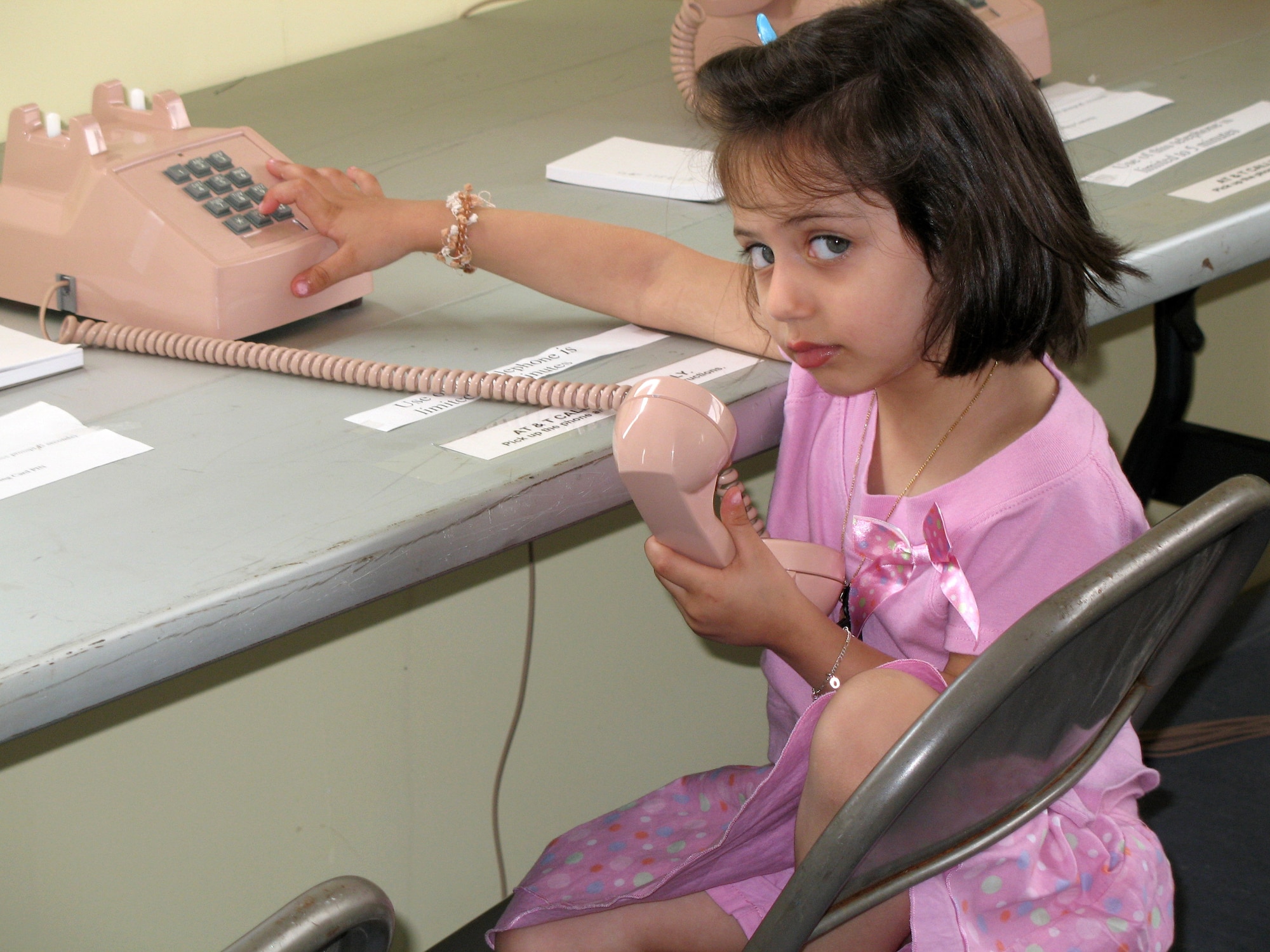 A young American who departed Lebanon plays with a telephone at Incirlik Air Base, Turkey, on July 22. The base has provided telephones, Internet service, television, beds and showers to the displaced American citizens while they wait to travel to the United States. (U.S. Air Force photo/Master Sgt. Bob Herron) 
