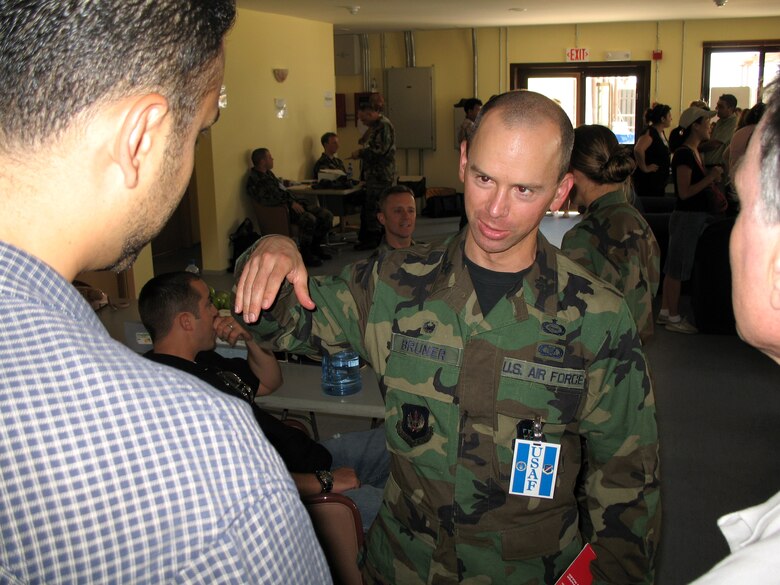 Lt. Col. Dale Bruner talks to members of the State Department at Incirlik Air Base, Turkey, on July 22. American citizens who departed Lebanon are arriving at the base for a short stop before traveling on to the United States. Colonel Bruner is commander of the 39th Services Squadron. (U.S. Air Force photo/Master Sgt. Bob Herron) 