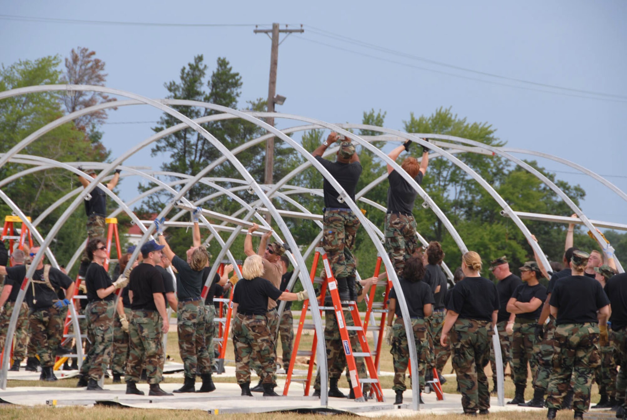 A combined team of Reserve and Guard medics set up a tent as part of their Expeditionary Medical Support System certification training at Ft. McCoy, Wisc., during Patriot '06, an Air National Guard-led exercise. (U.S. Air Force photo/Master Sgt. Chance Babin) 

