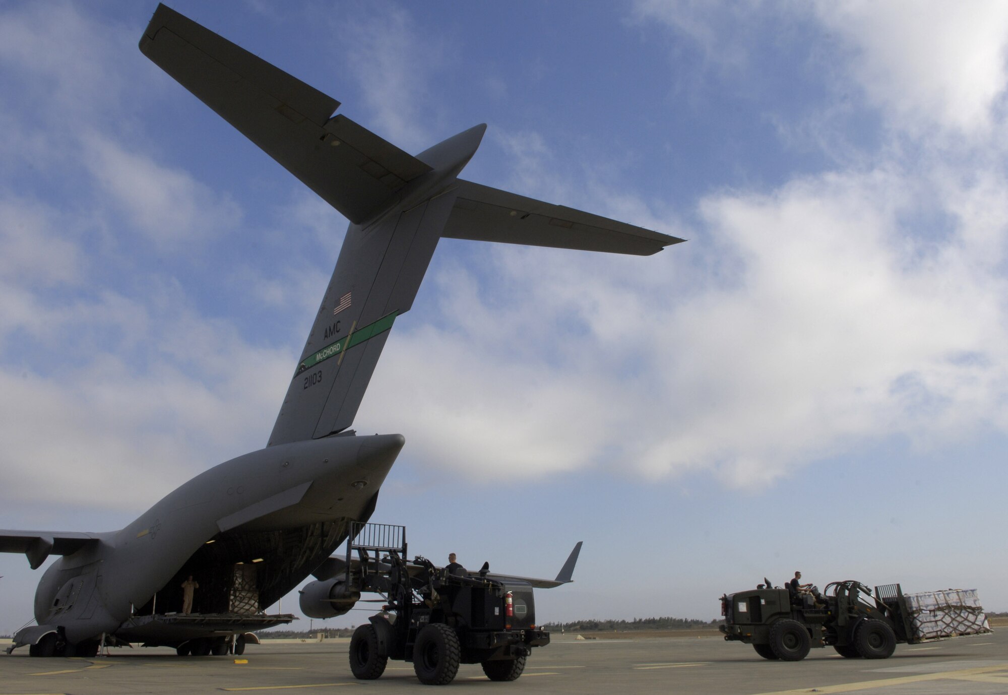 Pallets are off-loaded by forklift from a C-17 Globemaster III in Cyprus on July 22. C-17 crews from the 816th Expeditionary Airlift Squadron are filling their cabins with pallets of supplies such as water, Meals, Ready to Eat and cots for the American citizens leaving Lebanon. This C-17 transported 17 pallets, about 64,000 pounds, of cargo to Cyprus on this mission. (U.S. Air Force photo/Senior Airman Brian Ferguson) 
