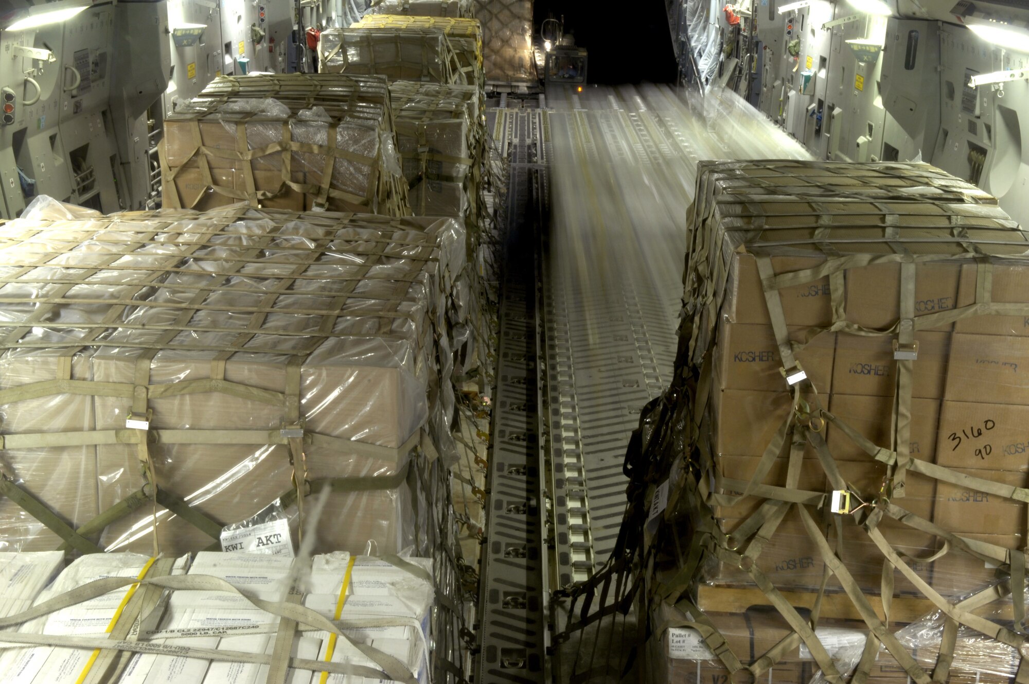 Pallets are loaded onto a C-17 Globemaster III in Southwest Asia for transport to Cyprus on July 22. C-17 crews from the 816th Expeditionary Airlift Squadron are filling their cabins with pallets of supplies such as water, Meals, Ready to Eat and cots for the American citizens leaving Lebanon. This C-17 transported 17 pallets, about 64,000 pounds, of cargo to Cyprus on this mission. (U.S. Air Force photo/Senior Airman Brian Ferguson) 