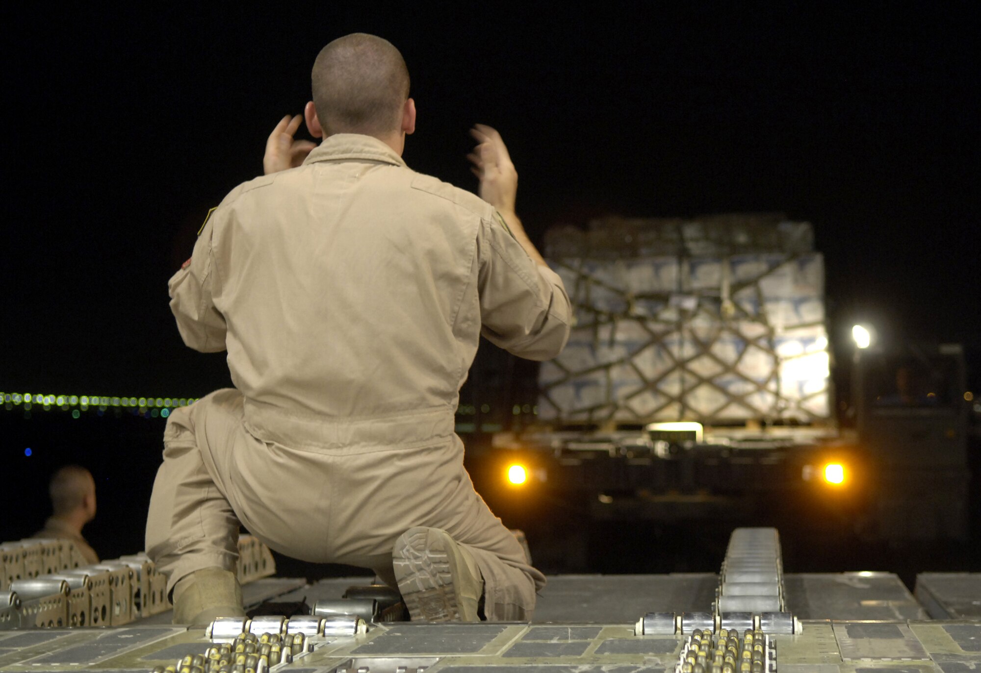 Airman 1st Class William Graham guides a K-loader up to the ramp of a C-17 Globemaster III in Southwest Asia on July 22. C-17 crews from the 816th Expeditionary Airlift Squadron are filling their cabins with pallets of supplies such as water, Meals, Ready to Eat and cots for the American citizens leaving Lebanon. This C-17 transported 17 pallets, about 64,000 pounds, of cargo to Cyprus on this mission. Airman Graham is a loadmaster with the 816th EAS. (U.S. Air Force photo/Senior Airman Brian Ferguson) 

