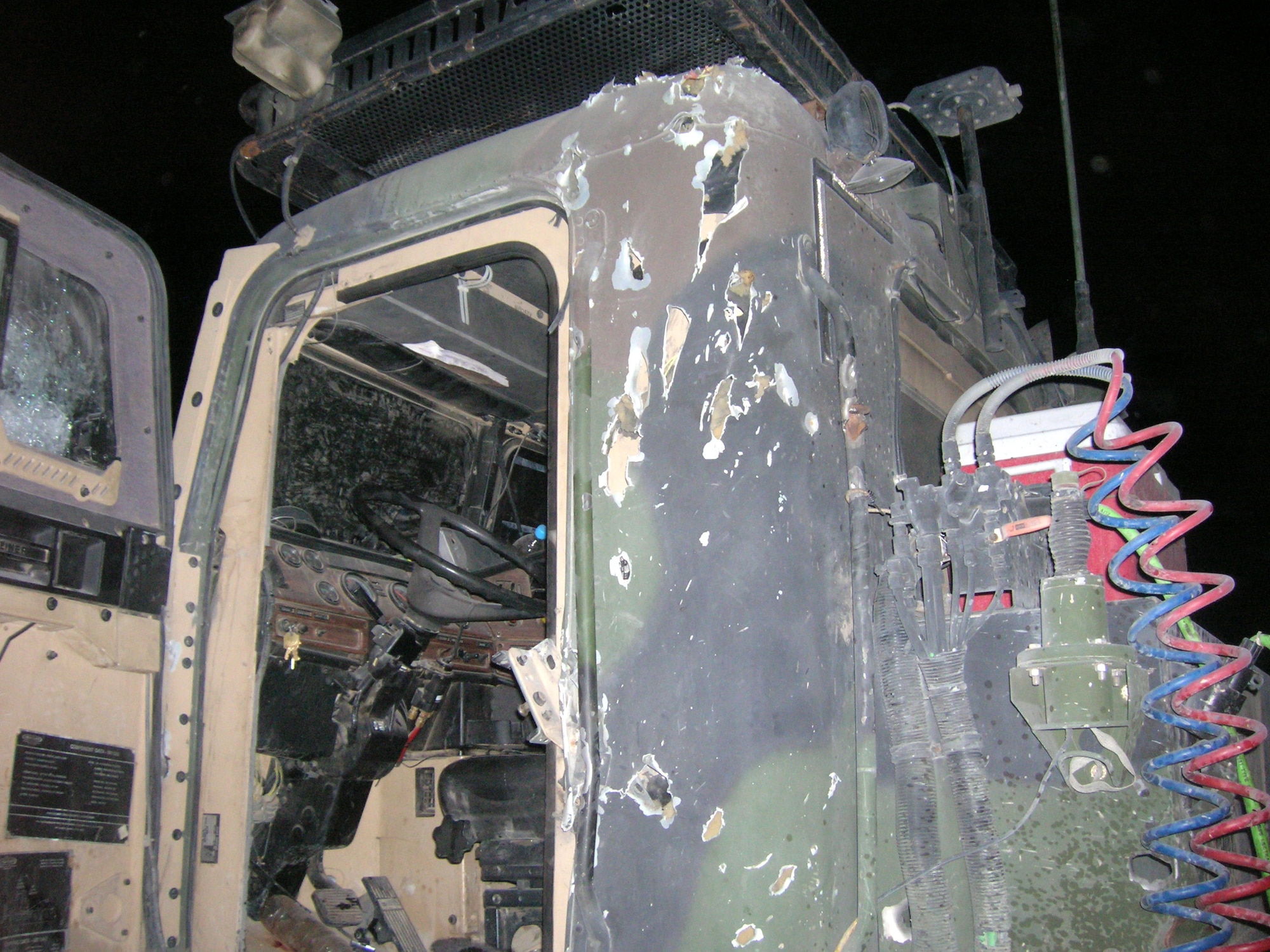 The results of an improvised explosive device are shown on a truck driven by Airman 1st Class Joshua Collins on July 20. Airman Collins, assigned to the 70th Medium Truck Detachment, suffered shrapnel wounds to his left ankle. He was treated at the Air Force Theater Hospital at Balad Air Base, Iraq, and sent through the Contingency Aeromedical Staging Facility to Germany. (U.S. Air Force photo/Senior Airman John Taylor) 
