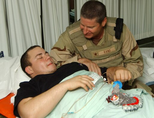 Brig. Gen. Robin Rand talks with Airman 1st Class Joshua Collins after presenting him with the Purple Heart at Balad Air Base, Iraq, on July 20. Airman Collins was wounded by a roadside bomb while driving a convoy truck north of Balad. General Rand is commander of the 332nd Air Expeditionary Wing. (U.S. Air Force photo/Senior Airman James Croxon) 