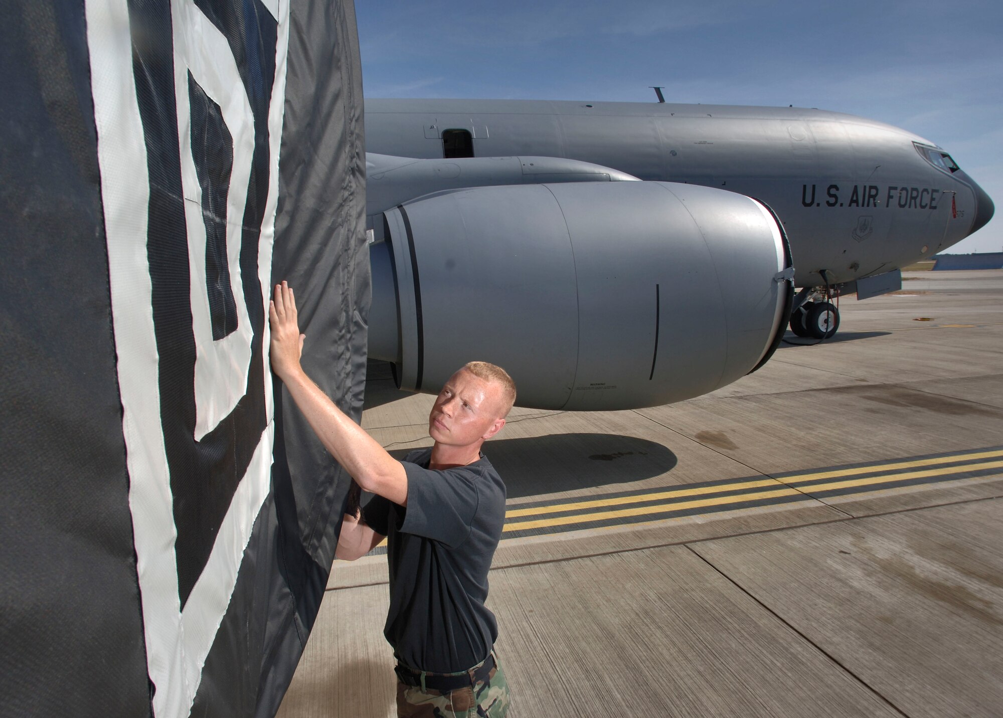 Staff Sgt. Craig Lambert checks an engine cover during a preflight inspection on a KC-135 Stratotanker at Royal Air Force Mildenhall, England, on July 24.  The sergeant is with the 100th Aircraft Maintenance Squadron. The "Box D" logo denotes the World War II roots of the 100th Air Refueling Wing, descendant of the 100th Bombardment Group (Heavy), that flew B-17G Flying Fortresses in World War II. (U.S. Air Force photo/Master Sgt. Lance Cheung)
